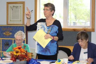 President Linda Bates greets delegates to the 92nd annual Women’s Institute Kingston Area Convention in Verona Tuesday morning. With Bates are secretary Valerie Smith and Liz Harrison from the Amherst Island chapter. Photo/Craig Bakay